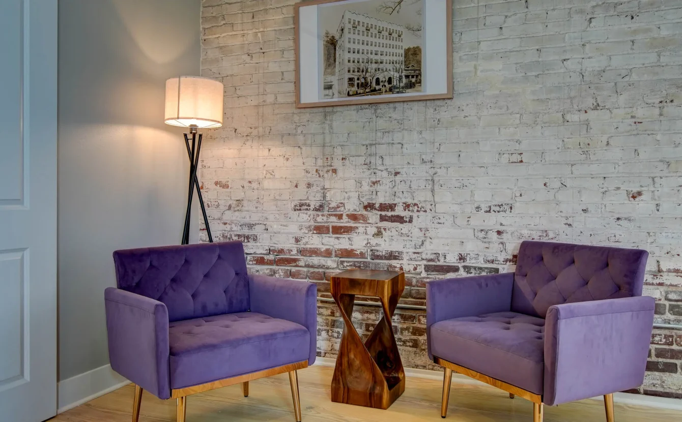 Lounge seating area with brick walls in downtown Hot Springs lodging