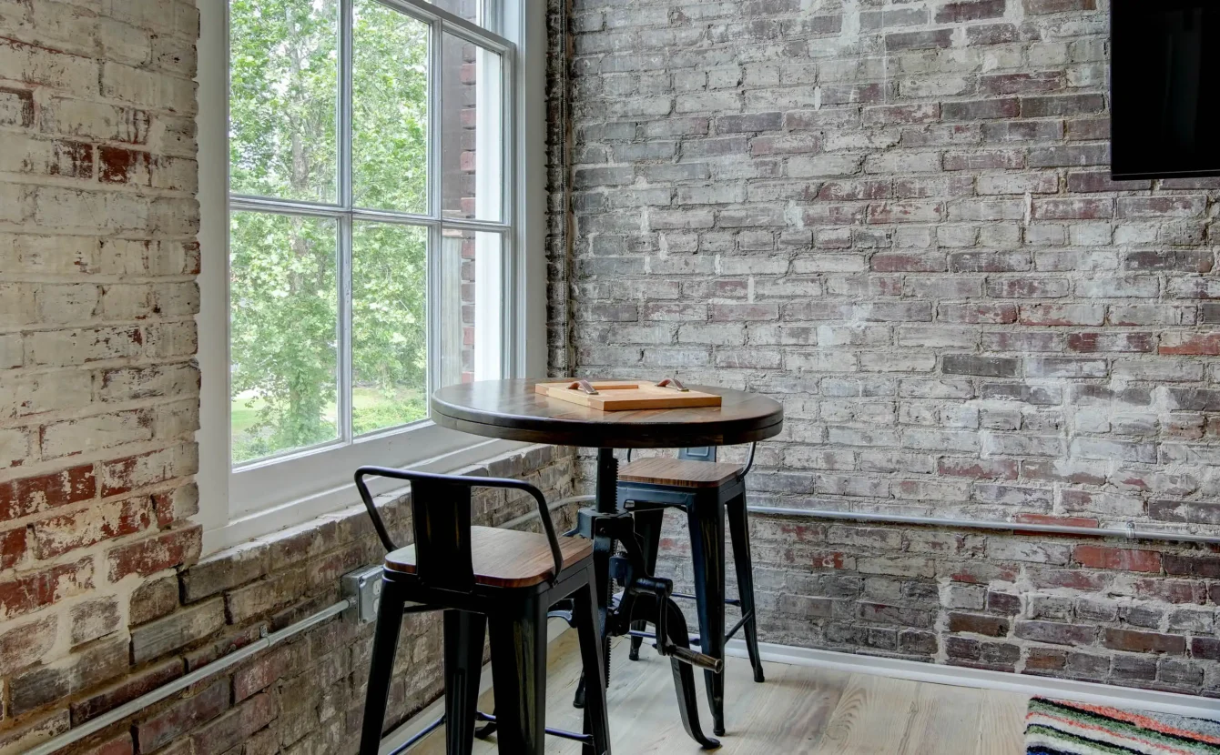 Dining nook by window in historic loft at Lofts at Creek Street