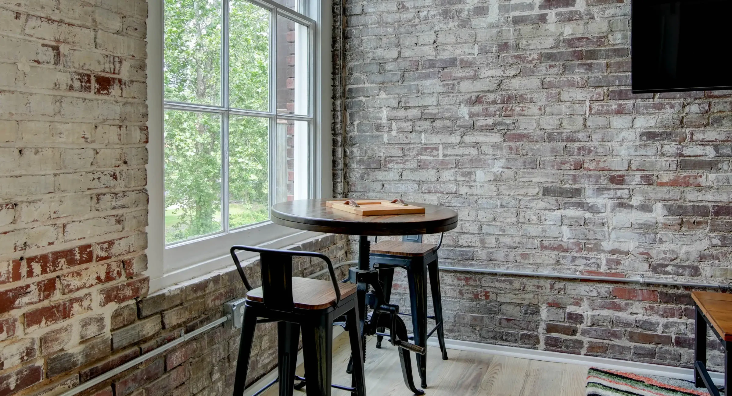 Dining nook by window in historic loft at Lofts at Creek Street