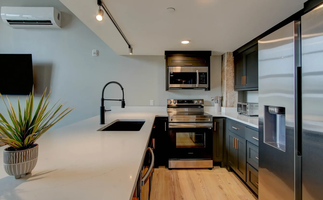 Modern kitchen with black fixtures in downtown Hot Springs loft rental