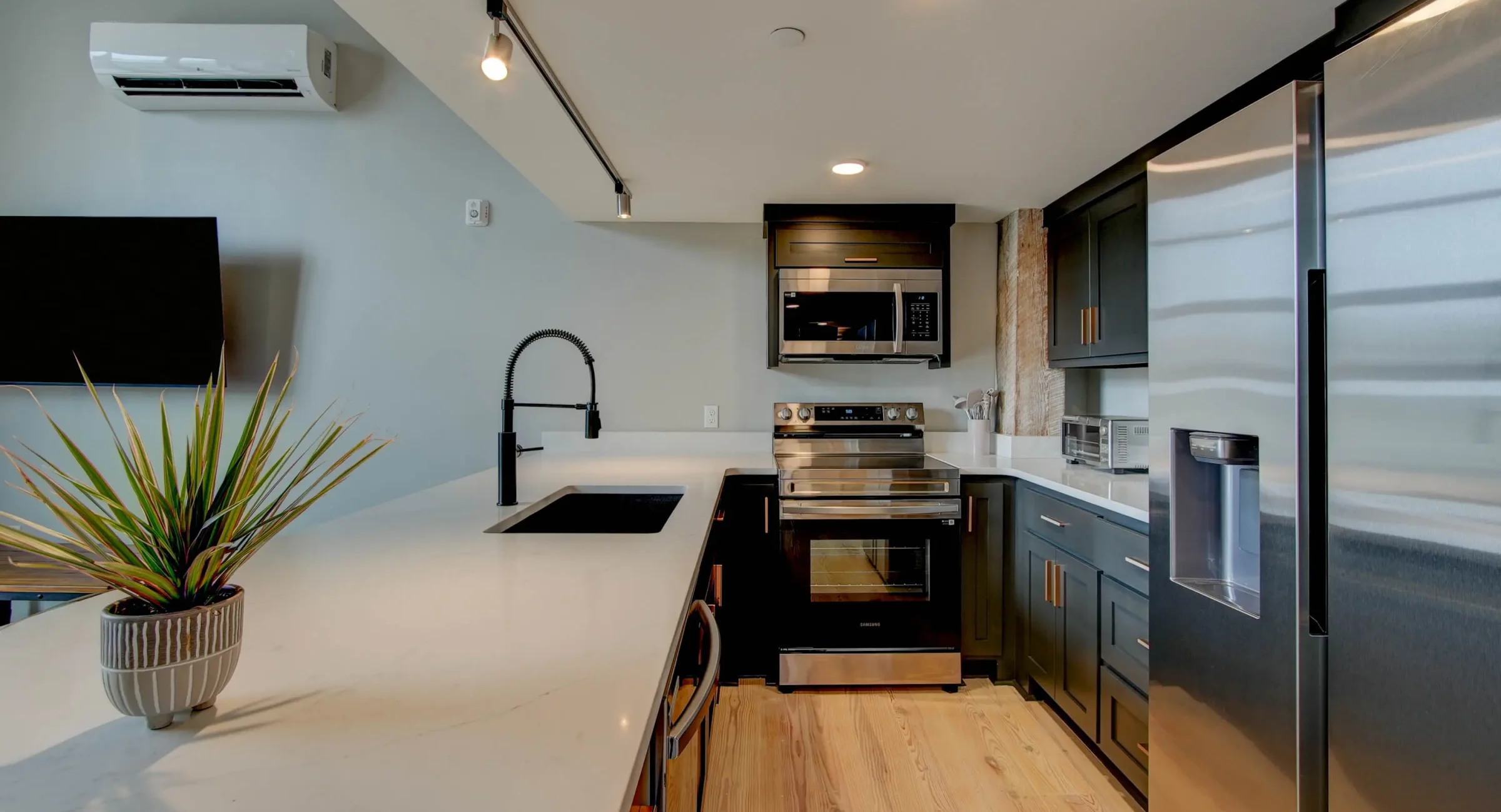 Modern kitchen with black fixtures in downtown Hot Springs loft rental