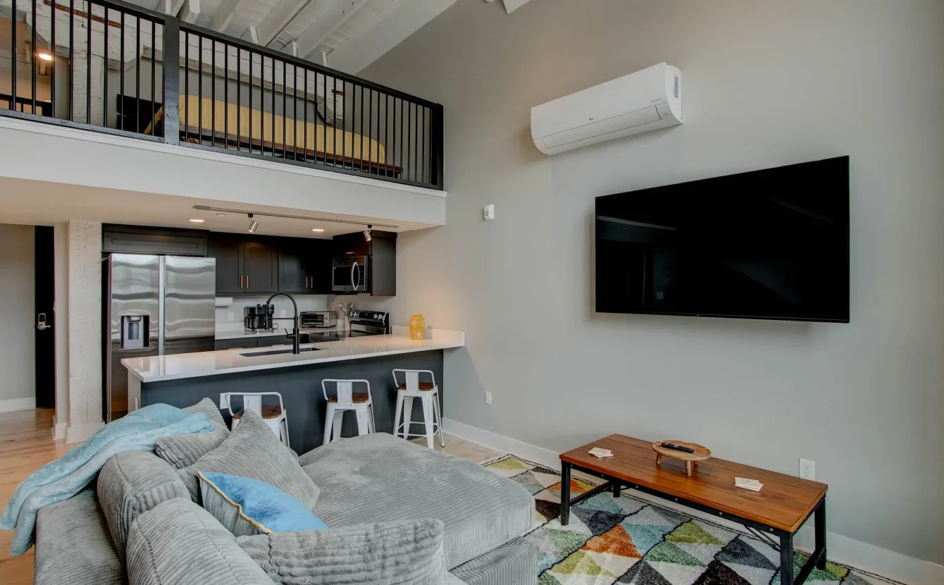 Open loft bedroom overlooking living area in downtown Hot Springs accommodations