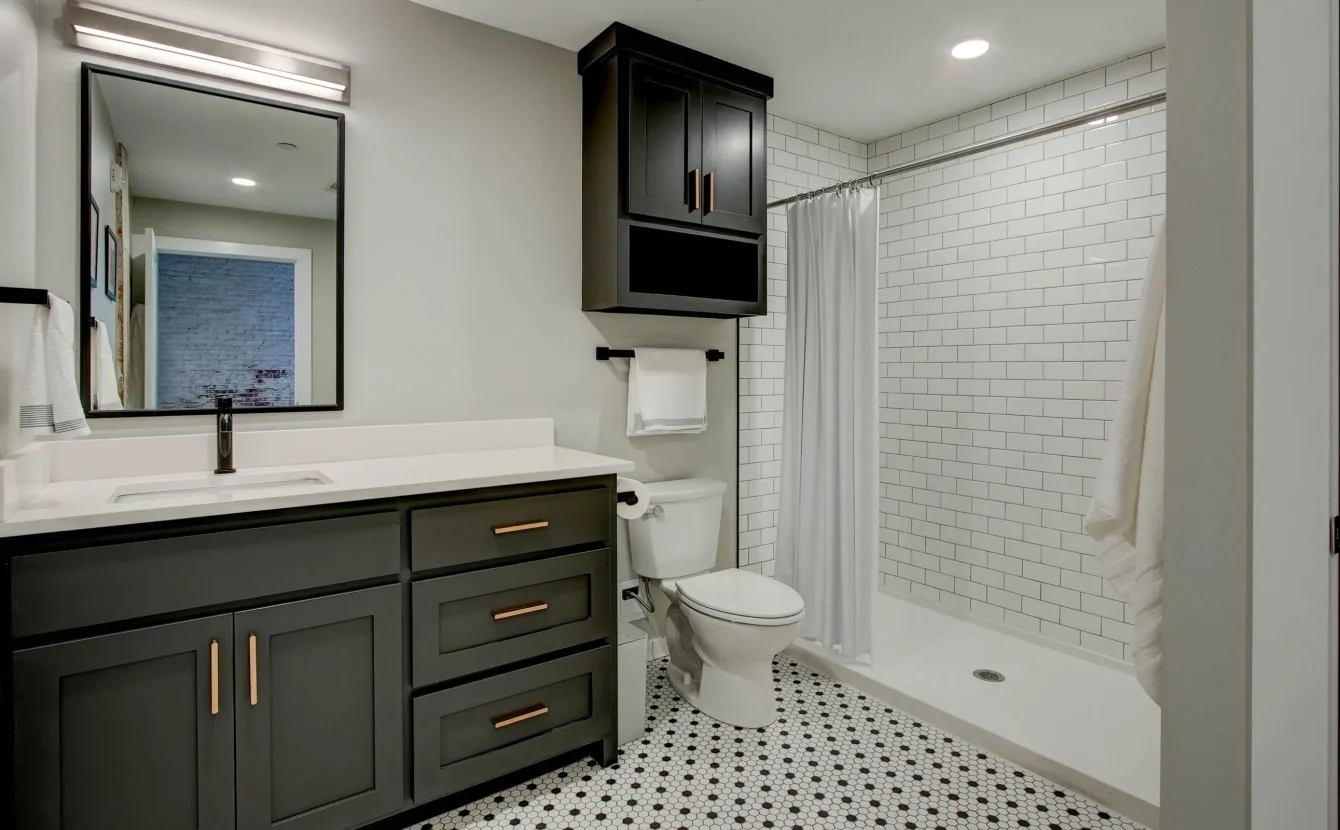 Bathroom with walk-in shower and subway tile in The Moody suite