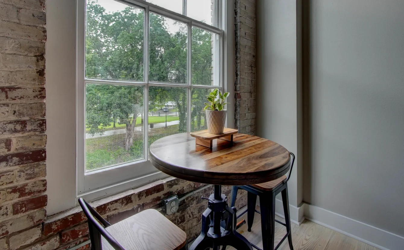 Dining table by window overlooking downtown Hot Springs in The Moody suite