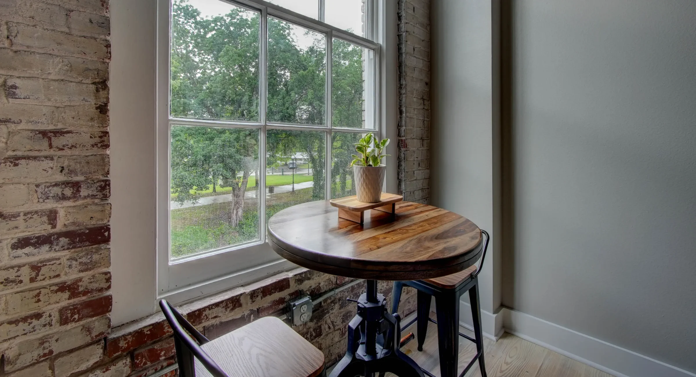 Dining table by window overlooking downtown Hot Springs in The Moody suite