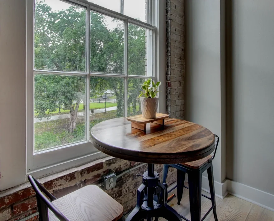 Dining table by window overlooking downtown Hot Springs in The Moody suite